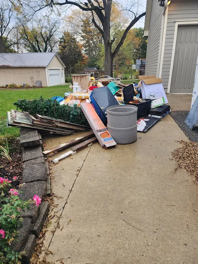 Dumpster being loaded with debris for 30 Yard Dumpster Rental in Williamston